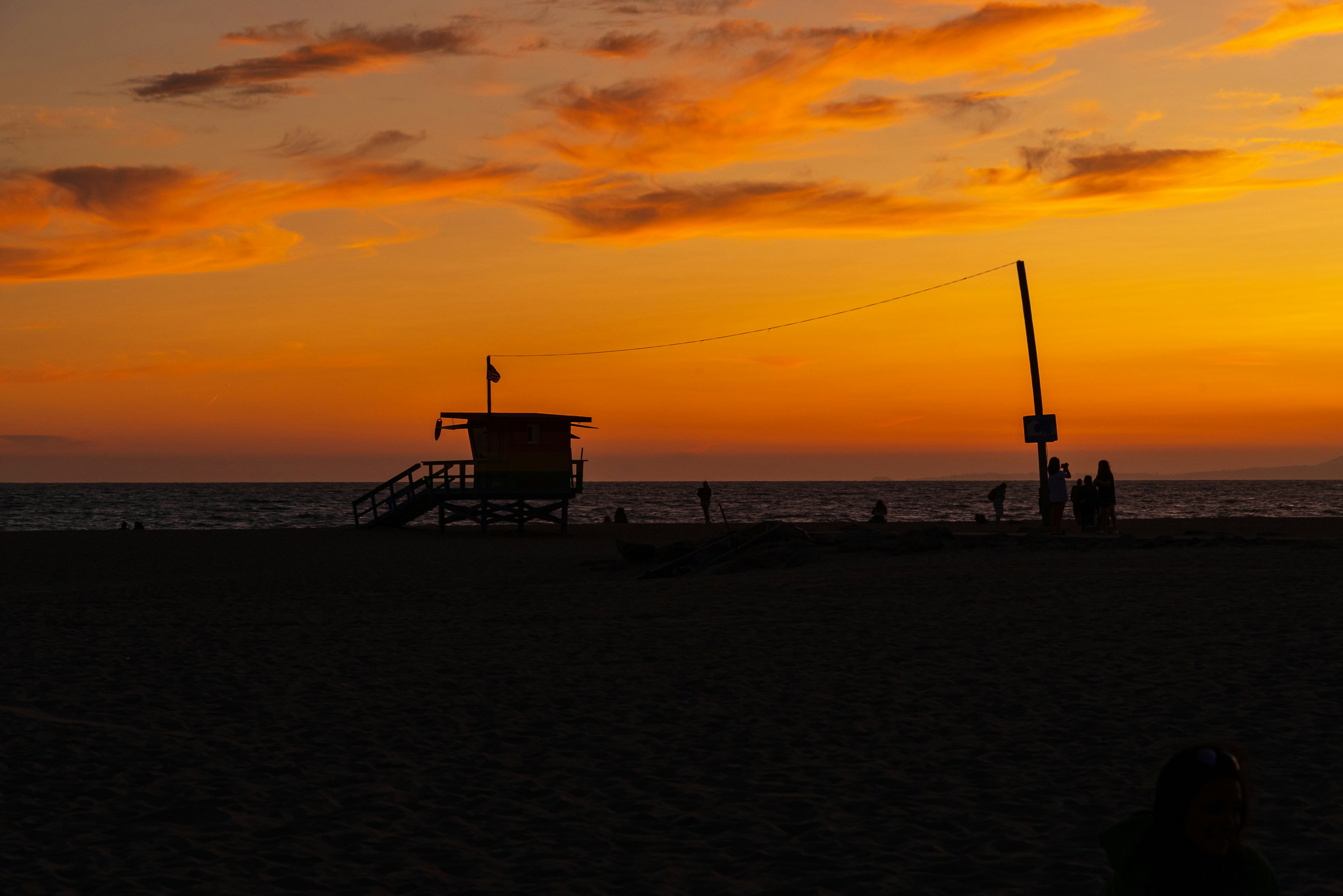 silhouette of person standing on beach during sunset